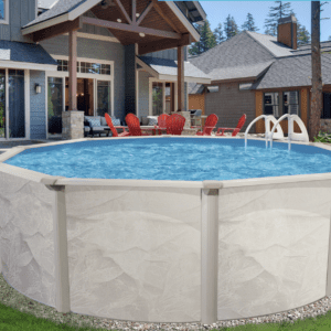 Above-ground swimming pool with clear blue water, surrounded by lounge chairs, in the backyard of an elegant house with lush greenery.